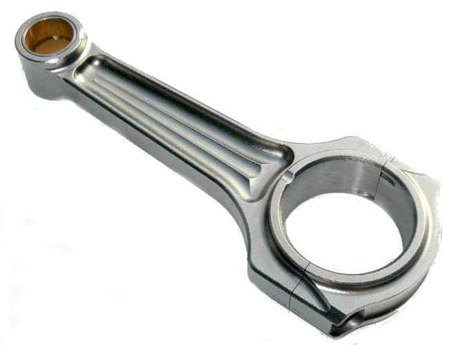 Diagrama de biela con partes etiquetadas: ojo (conexión al pistón), pie (conexión al cigüeñal), cuerpo (une ojo y pie), cojinetes (permiten giro en ojo y pie) y ranuras de lubricación.