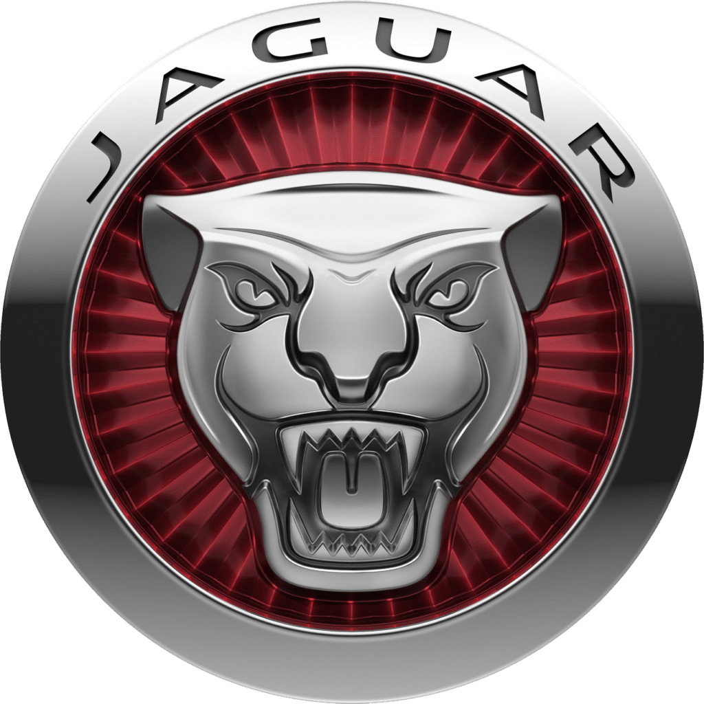El logo de Jaguar, que se muestra en la imagen, es un diseño icónico y elegante que representa la marca de automóviles de lujo Jaguar. El logo presenta una cabeza de jaguar en relieve, con detalles finos que resaltan la ferocidad y la gracia del animal. La cabeza del jaguar está enmarcada por un círculo rojo, lo que añade un toque de sofisticación y dinamismo al diseño. Este logo no solo simboliza la velocidad y la potencia de los vehículos Jaguar, sino también su compromiso con la excelencia y el lujo.